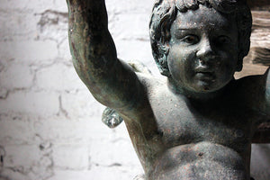 A Wonderful Pair of 19thC Cast Iron Relief Garden Ornaments in the Form of Winged Putto Sea-Creatures