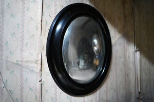An Early 20thC French Ebonised Convex Oval Wall Mirror