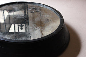 A Large Primitive Mid-Century Black Painted Oval Wall Mirror