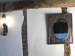 A Beautiful Arts and Crafts Embossed Copper Framed Wall Mirror