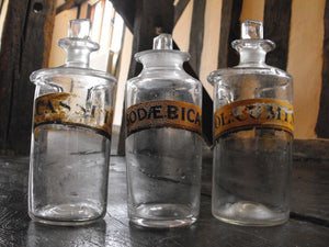 Three Late 19thC Glass Apothecary Bottles with Painted Banners to include Bicarbonate of Soda & two Oleum examples for Cassia & Cumin Oils
