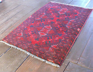 A Durable Red Afghan Rug: 119cm x 77cm